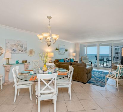 Savor morning coffee while watching the ocean from your stunning beachfront retreat with elegant coastal décor and floor-to-ceiling windows.