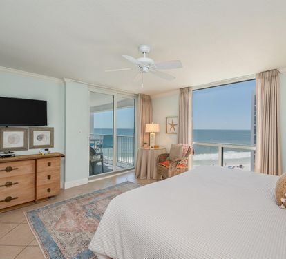Wake up to breathtaking ocean views from your private balcony in this serene coastal bedroom with beachy décor and peaceful ambiance.
