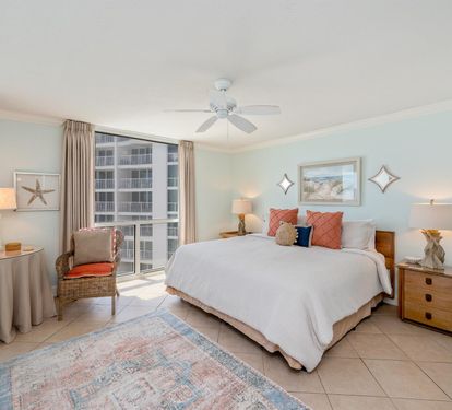 Drift off to sleep in your coastal-themed bedroom with plush bedding, ocean artwork, and warm lighting creating the perfect beachside retreat.