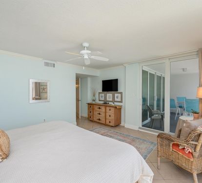 Drift off to sleep in your coastal bedroom with soft blue walls and sliding glass doors opening to your private balcony.