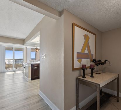 You'll love this stylish open-concept layout with modern artwork and glimpses of your private balcony beyond.