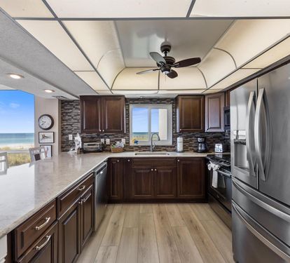 Your fully equipped kitchen offers granite counters and ocean views, perfect for preparing meals while watching the waves.