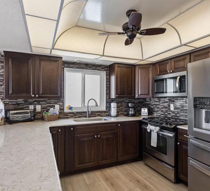 Your fully equipped kitchen awaits with stainless steel appliances, granite countertops, and rich wood cabinetry for memorable meal preparation.