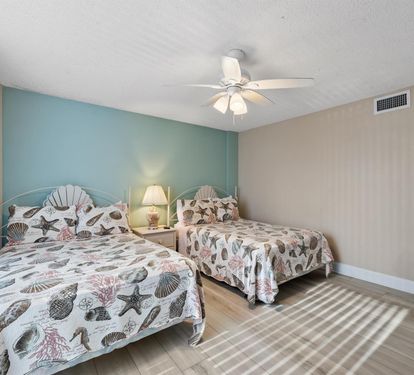 Sleep peacefully in your coastal-themed twin bedroom with seashell bedding and calming aqua walls that invite ocean dreams.