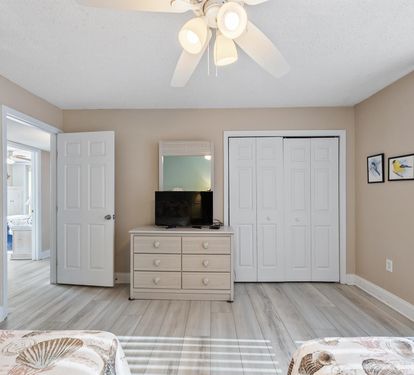 Your spacious bedroom features comfortable furnishings, ceiling fan, flat-screen TV, and ample closet space for all your belongings.