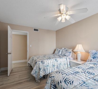 Drift off peacefully in your comfortable twin bedroom, where tropical bedding and gentle ceiling fan breezes create the perfect retreat.
