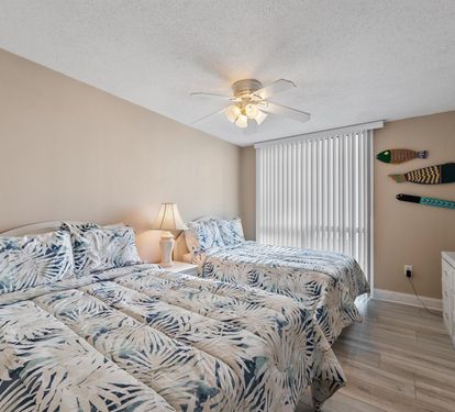 Drift off to sleep in this bright twin bedroom with tropical-themed bedding and coastal charm.