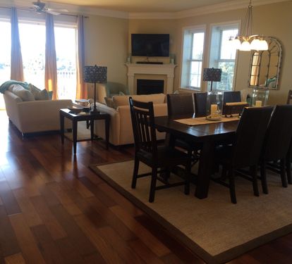 Corner unit with windows galore,wood flooring,wide living space & dining for 8