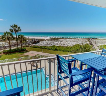 Picture yourself sipping morning coffee at your private balcony, where turquoise waters and white sand stretch endlessly before you. Palm trees sway gently while the pool sparkles below—pure coastal bliss awaits.