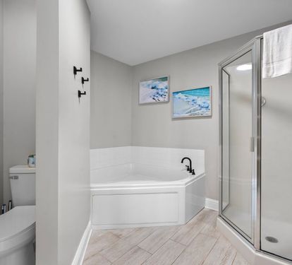 Lighthouse 901 Primary Bathroom with Corner Tub and Separate Step-in Shower