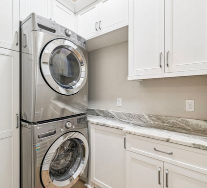 Stack Washer & Dryer Located in the Laundry Area