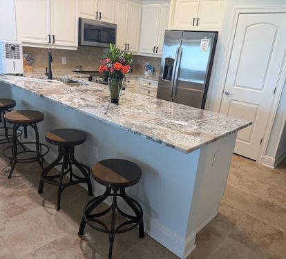 Spacious kitchen with granite countertops, stainless appliances, and bar seating—perfect for coffee mornings or family meals together.