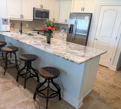 Spacious kitchen with granite countertops, stainless appliances, and bar seating—perfect for coffee mornings or family meals together.