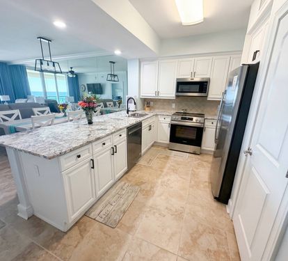 Spacious kitchen with granite countertops, stainless appliances, and bar seating—perfect for coffee mornings or family meals together.