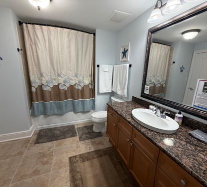 A bright, well-kept guest bathroom with everything your family needs for a comfortable stay. located off the King guest bedroom