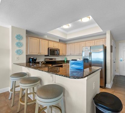 Your open kitchen features granite countertops, stainless steel appliances, and a breakfast bar perfect for morning coffee or casual dining together.