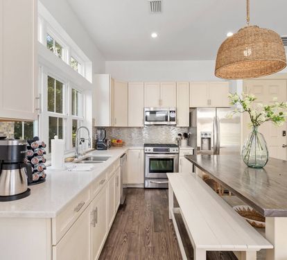 A real chef's kitchen—stainless appliances, white cabinets, room to cook