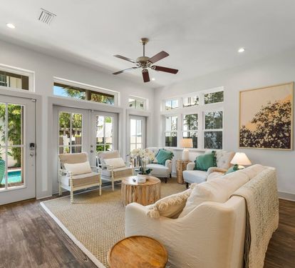 Airy living room with vaulted ceilings and French-door light