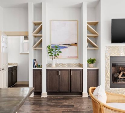 Warm wood built-ins and a fireplace anchor the open living space