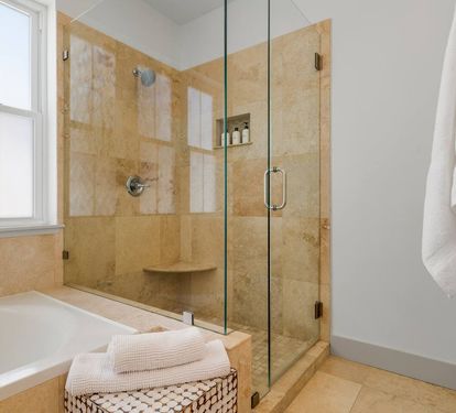 Roomy stone-tiled shower to wash off the Gulf