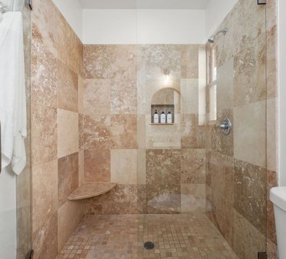Second-floor King Suite 3- ensuite bath features a spacious walk-in shower with built-in bench
