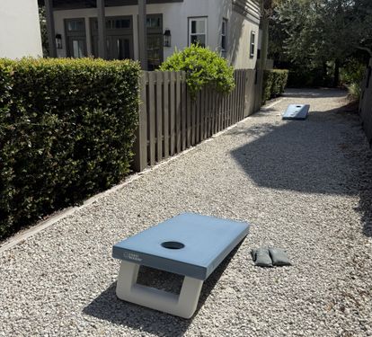 Private courtyard with cornhole and landscaped outdoor space