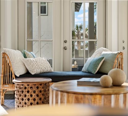 Sun-filled lounge with rattan seating and elegant indoor-outdoor charm