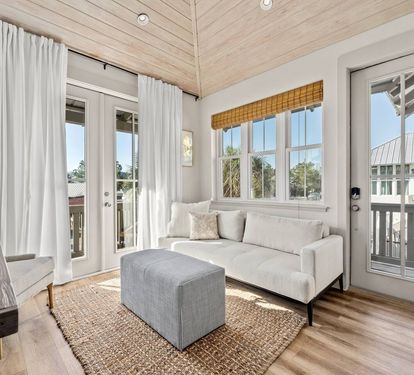 Kick back on the sofa as light pours through the French doors