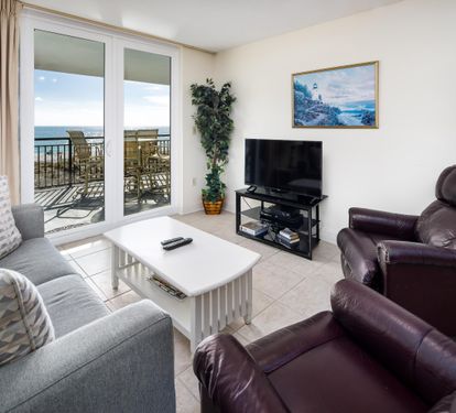 Living Area with Sofa Bed and Floor to Ceiling Sliding Glass Door to Balcony