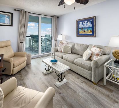 Living Area with sofa bed and Floor to Ceiling Sliding Glass Door to Balcony