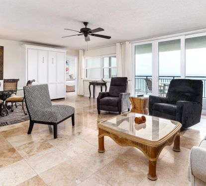 Open living room with  3 recliners and balcony access