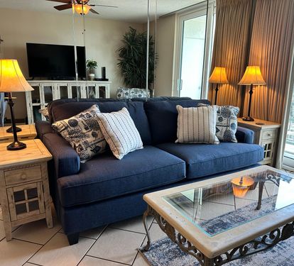 Living room with sofabed couch and balcony access