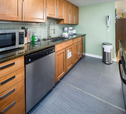Kitchen with island flat top and stove, stand alone icemaker