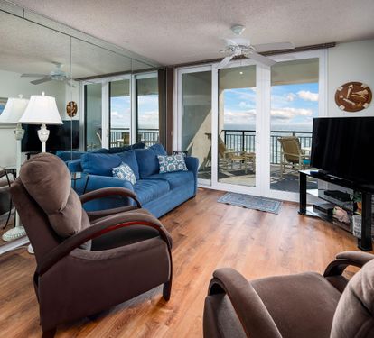 Living room and chairs with balcony access