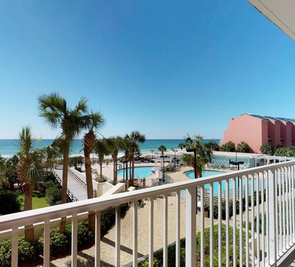 Private balcony overlooking the pools, beach, and Gulf.