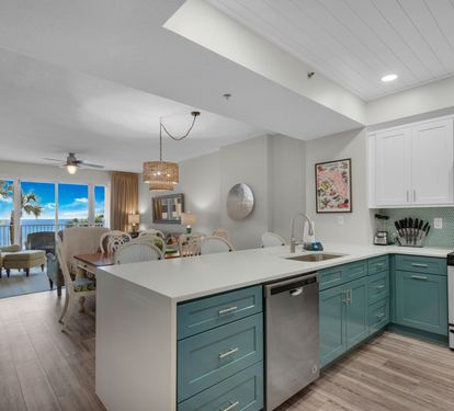 Open kitchen and living area with Gulf views and a TV. Living-room furniture shown has since been replaced.