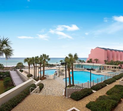 Wide view across the pools and beach to the Gulf.