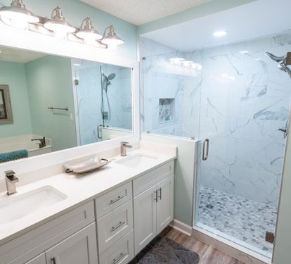 Updated primary bathroom with double vanity and walk-in shower.