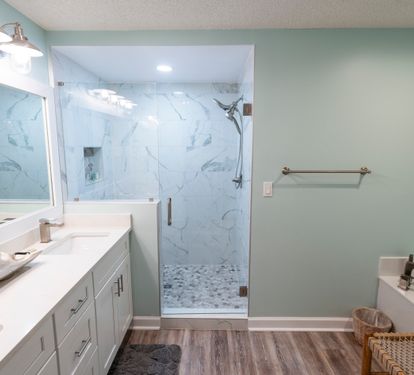 Walk-in shower and double vanity in the updated primary bathroom.