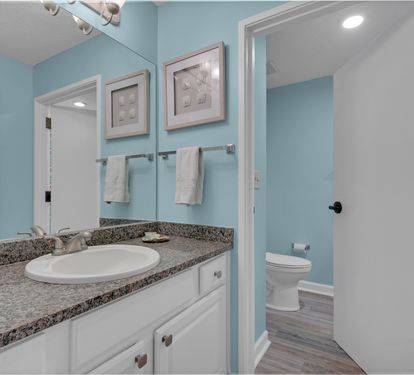 Front bathroom vanity; this bathroom is scheduled for an update in late 2026.