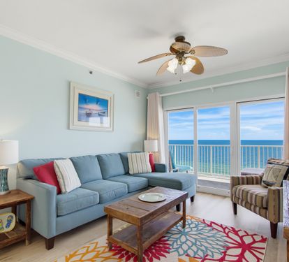 Comfortable Gulf-front living room with a wall-mounted TV.