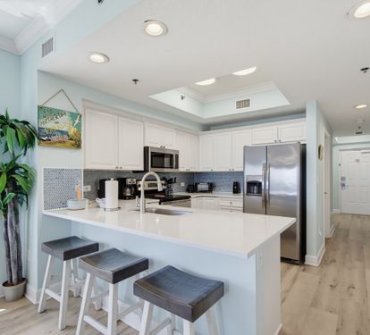 Updated kitchen with island seating and generous counter space.