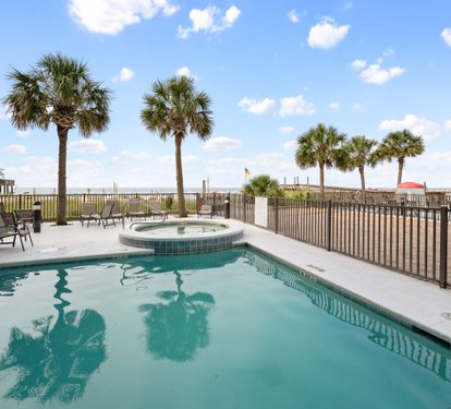Outdoor pool and hot tub area beside the Gulf.