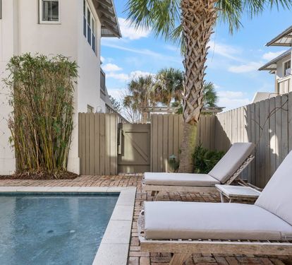 Claim a lounger between the palms and let the afternoon disappear. Two chairs, a shared side table, and nowhere else you need to be.