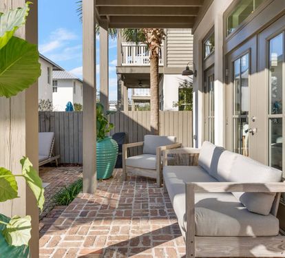 Grab the shaded patio sofa for an afternoon out of the sun. Ceiling fan overhead keeps the walkway seating cool even at midday.