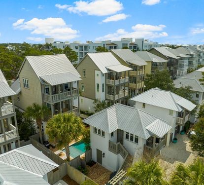 Find your rooftop tucked among the treetops, Gulf glinting past it. This bird's- eye view shows just how close the water really is.