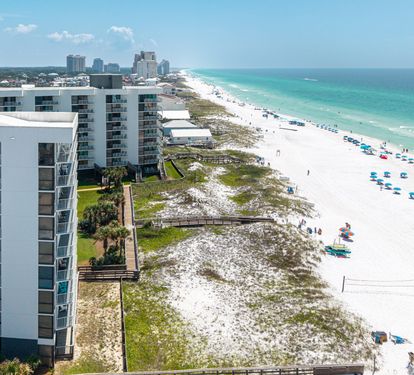 This beachfront property sits along pristine white sands and emerald waters, offering direct access to the beautiful coastline and stunning surrounding views.