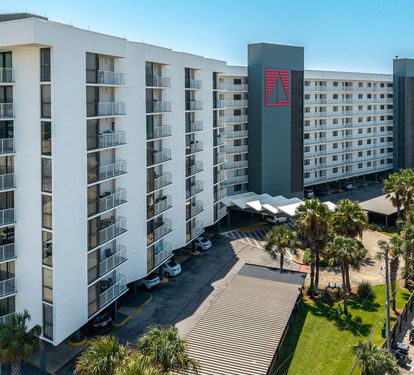 A beachfront property offering modern accommodations just steps from pristine white sand and emerald waters. The surrounding area features tropical landscaping and convenient access to nearby attractions.